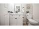 Updated bathroom with a white vanity, matte black hardware, framed mirror and new light fixture at 3423 W Walsh Pl, Denver, CO 80219