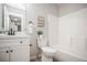 Updated bathroom with a white vanity, matte black hardware, framed mirror and tub shower at 3423 W Walsh Pl, Denver, CO 80219