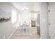 Bright dining area adjacent to the kitchen with modern table and natural light at 3423 W Walsh Pl, Denver, CO 80219