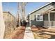 Charming home with a cozy front porch and a walkway leading to the entrance at 3423 W Walsh Pl, Denver, CO 80219