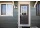 Close-up of a modern front door with sidelight and stylish exterior lighting at 3423 W Walsh Pl, Denver, CO 80219