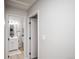 Hallway leading to a bathroom with white vanity at 3423 W Walsh Pl, Denver, CO 80219