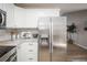 Spacious kitchen with stainless steel refrigerator, ample storage, and modern finishes at 3423 W Walsh Pl, Denver, CO 80219