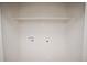 Laundry room with hookups and shelving at 3423 W Walsh Pl, Denver, CO 80219