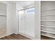 Bathroom features tiled shower with glass door and built-in shelving at 553 Homestead Ave, Brighton, CO 80601