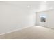 Spacious carpeted bedroom with recessed lighting and a window offering neighborhood views at 553 Homestead Ave, Brighton, CO 80601