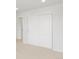 Carpeted bedroom with a closet featuring sliding doors and a window offering a neighborhood view at 553 Homestead Ave, Brighton, CO 80601