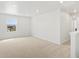 Bright, carpeted bedroom with recessed lighting and a large window overlooking the neighborhood at 553 Homestead Ave, Brighton, CO 80601
