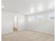Carpeted bedroom with recessed lighting, multiple windows, and a doorway leading to another room at 553 Homestead Ave, Brighton, CO 80601