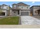 Charming home with stone accents, a well-maintained lawn, and a two-car garage at 553 Homestead Ave, Brighton, CO 80601