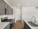 Contemporary kitchen with grey cabinetry, stainless steel appliances, and gas range at 553 Homestead Ave, Brighton, CO 80601