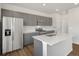 Well-equipped kitchen with stainless steel appliances, grey cabinets, and a center island at 553 Homestead Ave, Brighton, CO 80601