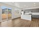 Modern kitchen with stainless steel appliances and a kitchen island features views of the backyard at 553 Homestead Ave, Brighton, CO 80601
