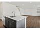 Modern kitchen island with stainless steel dishwasher overlooks the spacious living area at 553 Homestead Ave, Brighton, CO 80601