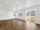 Open living room featuring hardwood floors and sliding glass doors that provide natural light at 553 Homestead Ave, Brighton, CO 80601