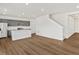 Open floor plan seamlessly connecting the kitchen and living room with hardwood floors at 553 Homestead Ave, Brighton, CO 80601