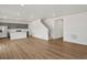 Open-concept living area with hard floors, staircase, and adjacent kitchen at 553 Homestead Ave, Brighton, CO 80601