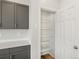 Pantry with shelving located next to gray kitchen cabinets and white countertops at 553 Homestead Ave, Brighton, CO 80601
