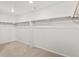 Spacious walk-in closet featuring neutral carpeting and built-in shelving rods for organized storage at 553 Homestead Ave, Brighton, CO 80601