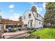 Inviting backyard featuring a covered patio, outdoor dining, hot tub, landscaped lawn, and hammock at 1690 Spruce St, Denver, CO 80220