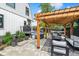 Backyard with hot tub, covered seating, and flower garden provides the perfect space to gather and relax at 1690 Spruce St, Denver, CO 80220