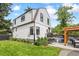 Charming home featuring a well-maintained lawn and inviting backyard with a hot tub and patio at 1690 Spruce St, Denver, CO 80220