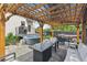 Enjoy outdoor living on this covered patio featuring an outdoor dining table, fire pit and hot tub at 1690 Spruce St, Denver, CO 80220
