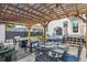 Relaxing covered backyard patio with an outdoor dining area, comfortable seating and a hot tub at 1690 Spruce St, Denver, CO 80220