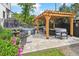 Backyard oasis with a hot tub, a seating area with a pergola, and a well manicured lawn with vibrant flowers at 1690 Spruce St, Denver, CO 80220