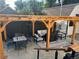 Backyard patio features a wooden pergola with outdoor seating and dining area at 1690 Spruce St, Denver, CO 80220