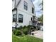 A backyard with garden beds and a patio area, framed by a white house facade with dark window trim at 1690 Spruce St, Denver, CO 80220