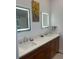 Bathroom features dual sinks with modern fixtures, vanity, and decorative artwork at 1690 Spruce St, Denver, CO 80220