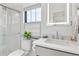 Bathroom featuring modern vanity, undermount sink, and tiled shower with glass door at 1690 Spruce St, Denver, CO 80220