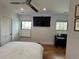 Bedroom features hardwood floors, television, and neutral decor at 1690 Spruce St, Denver, CO 80220