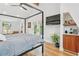 Bright bedroom featuring a four-poster bed, hardwood floors, a ceiling fan, and double doors leading to the outside at 1690 Spruce St, Denver, CO 80220