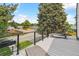 Outdoor deck featuring lounge chairs, rod iron railing, and views of the lush neighborhood at 1690 Spruce St, Denver, CO 80220
