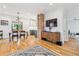Stylish dining area featuring wood floors, brick accent wall, and modern lighting fixtures at 1690 Spruce St, Denver, CO 80220