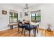 Charming dining area with lots of natural light, wood table and chairs, and hardwood floors at 1690 Spruce St, Denver, CO 80220