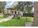 Beautiful home featuring a covered porch, balcony, and lovely landscaping in the front yard at 1690 Spruce St, Denver, CO 80220
