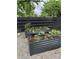 Raised garden beds filled with plants and soil, with a gravel pathway visible in the backyard at 1690 Spruce St, Denver, CO 80220