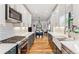 Beautiful kitchen featuring modern appliances, sleek cabinetry, and an open layout leading to the dining area at 1690 Spruce St, Denver, CO 80220