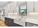 Modern kitchen with white cabinets, gold hardware, farmhouse sink, and stainless steel appliances at 1690 Spruce St, Denver, CO 80220