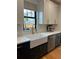 Kitchen featuring stainless steel appliances, a farmhouse sink, and sleek cabinetry at 1690 Spruce St, Denver, CO 80220