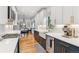 Modern kitchen featuring stylish cabinets, countertops, and stainless steel appliances, plus dining area views at 1690 Spruce St, Denver, CO 80220