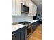 Gourmet kitchen features stainless steel appliances and modern white countertops and dark-toned cabinets at 1690 Spruce St, Denver, CO 80220