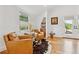 Cozy living room featuring hardwood floors, comfortable seating, and lots of natural light at 1690 Spruce St, Denver, CO 80220