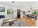 Open living space with wood floors, comfortable seating, and a dining area adjacent to the kitchen at 1690 Spruce St, Denver, CO 80220