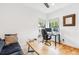 Comfortable living room featuring hardwood floors, natural light, and modern minimalist furniture at 1690 Spruce St, Denver, CO 80220