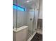 Modern shower featuring white subway tile, rain shower head, handheld sprayer, and glass enclosure at 1690 Spruce St, Denver, CO 80220