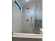 Modern shower featuring white subway tile, rain shower head, handheld sprayer, and glass enclosure at 1690 Spruce St, Denver, CO 80220